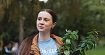 Volunteer, walking and woman with plant in nature for community service, gardening and project. Environment, sustainability and person with leaves in park for NGO outreach, eco friendly and ecology