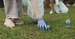 Garbage, cleaning and volunteer in outdoor park for community service, waste or trash pollution. Charity, bags and ngo worker tidying grass of dirt for eco friendly outreach project in environment.