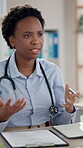 Black woman, doctor and consultation or discussion at office for explaining, advice and symptoms. Female person, specialist and cardiologist with paperwork and contract for surgery agreement