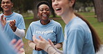 Woman, volunteer and outdoor together for applause, success and charity event with goals for change. People, diversity and scrum with cheers, happy and solidarity for social responsibility in park