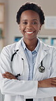 Black woman, confidence and face as doctor in clinic or hospital with happiness, stethoscope and smile. African, female person and portrait as medical professional in healthcare, wellness or services