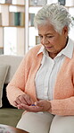 Senior woman, pill box and medication for weekly dose with organizing in home for retirement. Elderly, female person and pharma for health in lounge with wellness, diabetes and treatment as pensioner