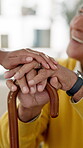 Elderly man, cane and holding hands in home with support, empathy and wellness for person with disability. Senior care, happy and walking stick in house with love or nursing for homecare and trust