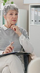 Mature woman, psychologist and writing with clipboard on sofa for notes, feedback or assessment at clinic. Female person, psychiatrist or therapist listening to patient for healthcare advice or help