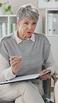 Mature woman, therapist and consulting with clipboard on sofa for advice, notes or assessment at clinic. Female person, psychiatrist or psychologist talking to patient for healthcare, support or help