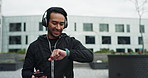 Fitness, man or happy in city with music, phone or check smart watch for progress or distance. Good energy, athlete or tech at buildings for exercise, wellness or favorite workout playlist in Brazil
