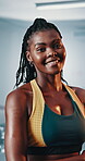 Black woman, smile and arms crossed in gym for training, strength or muscle building for fitness development. Confidence, portrait and happy African person for workout, exercise and challenge