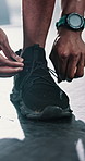 Black person, hands and tying with shoes in fitness for running, workout or preparation at gym. Closeup of African runner or athlete getting ready with tie or sneakers for training at health club