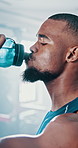 Fitness, drinking water and black man in gym, exercise and hydration with wellness, nutrition and healthy. African person, athlete and thirsty with aqua, liquid and body care with sports and routine