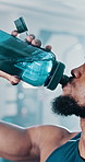 Fitness, water bottle and black man in gym, exercise and hydration with wellness, nutrition and routine. African person, athlete and thirsty with aqua, liquid and body care with sports and healthy