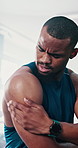 Black man, fitness and shoulder injury with pain or ache from accident or muscle tension at gym. Active African or male person with sore arm, joint or sprain in discomfort or exercise at health club