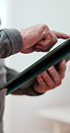 Senior man, hands and scrolling with tablet for news, social media or online browsing at home. Closeup of elderly male person with technology for app navigation, information or connectivity at house