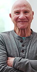 Crossed arms, happy and face of senior man in nursing home with smile, confidence and pride. Retirement, relax and portrait of elderly person with laugh, positivity and joy for old age in living room