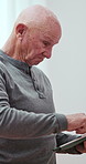 Tablet, home and elderly man on internet for social media, website and online information. Retirement, relax and senior person on digital tech for search, reading news and contact in living room
