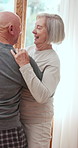 Senior, happy couple and dancing with hug for love, romance or enjoying day in retirement home. Elderly man and woman in sway, motion or movement for anniversary, holiday or bonding together at house