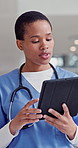 Doctor, hands and black woman in hospital, tablet and typing with internet, connection and research. Person, medical or closeup with professional, communication or digital app with results or uniform