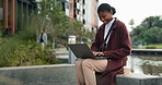 Black woman, laptop and outdoor in city with typing for remote work and digital research for copywriting job. Urban, web and typing article of freelancer planning a news post for social media