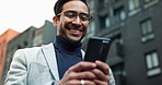 Business, Asian man and smile outdoor with texting on smartphone for social media in New York. Male person, below and happy with browsing internet for entertainment, networking and communication