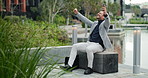 Phone, celebration and man in business park with good news notification for promotion, job search or recruitment. Excited, dancing or happy businessman outside with smartphone for online announcement