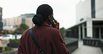 Black woman, phone call and city walk with travel, conversation or communication outdoors. African consultant, back and business discussion with networking, work trip and smartphone on urban street