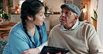 Senior man, caregiver and discussion with tablet at house for medical report, Telehealth consulting and wellness. Woman, patient and digital to check health, treatment information and medicine app 