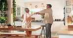 Senior, couple and smile with dancing in kitchen for favorite song, retirement wellness and kissing in home. Elderly, people and celebration together in house with romance, support or radio playlist