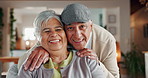 Elderly couple, kiss and happy in home for love, affection or comfort in relationship. Retirement, people or portrait in living room for trust, care and bonding with support or commitment in marriage
