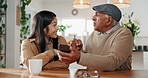 Senior man, daughter and laughing with phone in home for picture memory, tech savvy and high five for learning app. Family, woman and father at dining table with helping hand for teaching smartphone