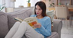 Mature woman, reading book or relax on sofa for hobby, fictional tale or adult literature at home. Lecturer, comfort or peace in living room with novel, knowledge or curriculum preparation for school