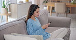 Girl, texting and music on earphones with mobile phone, living room and happiness for communication in home. Woman, technology and singing on streaming service, online playlist and ai software in app