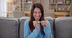 Happy, pregnancy test and woman on sofa with celebration for positive result in living room at home. Excited, maternity and joyful female person with prenatal stick for ivf success with pregnancy.