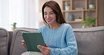 Girl, tablet and laughing with scroll with mobile app, living room and happiness for communication in home. Woman, technology and online dating for networking, connection and relationship on website