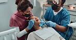 Dentist, patient and teeth check with dental assistance for orthodontics exam in healthcare consultation. Cleaning, assessment and medical inspection for oral hygiene and mouth wellness of woman