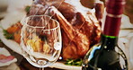 Glass, celebration and food for dinner, house and wine for bottle for thanksgiving, event and table. Home, holiday and feast for festive season, Christmas and turkey for hosting, drinks and alcohol