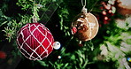 Christmas tree, home and slow motion with baubles, light and decoration for tradition, culture or event. Ornament, leaves and shine with closeup for xmas party, celebration and festive cheer in house