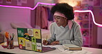 Girl, laptop and writing in notebook at night in home, check or study with reading article for research. Black woman, computer and notes in bedroom with neon light, review or assessment for elearning