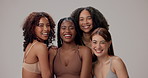 Happy women, diversity and natural beauty with inclusion for empowerment or skincare on a gray studio background. Portrait, diverse group or female models with smile for fashion, care or wellness