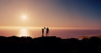 Couple, silhouette and hiking with high five at sunset with ocean, sky and mock up space on vacation in summer. People, outdoor and mountain with goals, sea and success with trekking in New Zealand