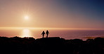 Couple, silhouette and hiking on mountain at sunrise with ocean, sky and mockup space on vacation in summer. People, outdoor and together on hill with view, sea or horizon for trekking in New Zealand