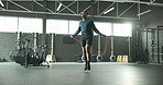 Jump, skipping rope or black man in gym for fitness for body health, training or cardio exercise in challenge. Development, agility or male African athlete with wellness, mobility workout or energy