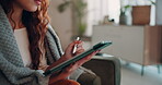 Woman, home and stylus on tablet with blanket on couch for browsing social media and internet.Female person, house and touchscreen pen in living room on sofa for online communication and networking