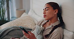 Woman, bed and sleepy on smartphone with hot water bottle for warmth and cold at home. Female person, bedroom and tired or exhausted with browsing internet for social media, networking or connection 