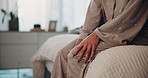 Woman, hands and knee pain with injury on bed for joint ache, inflammation or fibromyalgia at home. Closeup, female person or patient with arthritis, sore leg or strain for sprain in bedroom at house