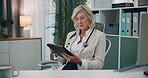 Mature, doctor and woman with tablet in office for healthcare administration, clinic management or research. Professional, worker and digital technology with stylus for writing patient report at desk