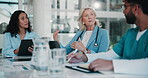 Coaching, healthcare and meeting with people in boardroom of hospital together for planning or research. Doctors, nurses and teamwork with professional medicine group in clinic for medical education