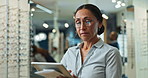 Woman, optometrist and tablet with eyewear at store for eye exam results, medical prescription and retail inventory. Smile, female person and digital for assessment schedule, stock and online service