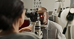 Eye exam, man and expert in clinic for healthcare, consultation and procedure. Woman optometrist, patient and equipment in practice for diagnosis, medical process or assessment for wellness or vision