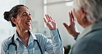 Happy woman, high five and elderly care with patient for teamwork, consultation or advice at hospital. Female person, medical employee and senior with success for healthcare support, trust or help