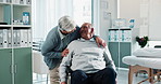 Senior, couple and happy with wheelchair in clinic for healthcare support, consultation and comfort for rehabilitation. Elderly, people and hug in hospital for medical checkup, caregiver or treatment