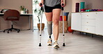 Person with a disability, feet and crutches at rehabilitation clinic for health or advice. Patient, walking and physiotherapy for prosthetic leg as amputee at wellness center for balance or mobility